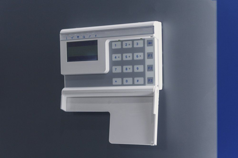 A White Keypad Is Sitting On A Blue Wall — NFL Electrical In Mount Archer, QLD
