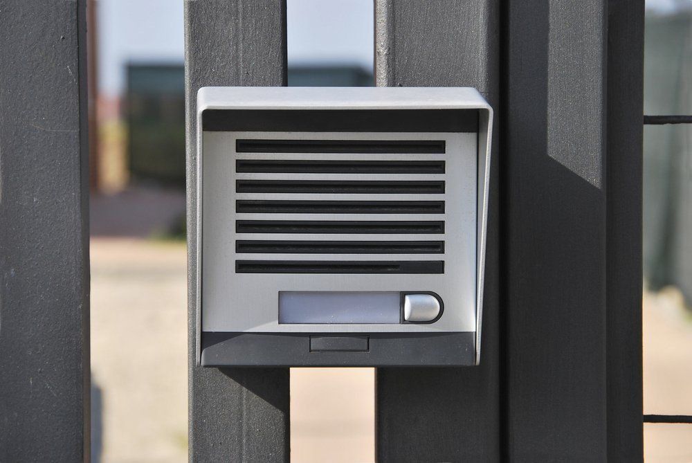 A Doorbell Is Attached To A Metal Fence — NFL Electrical In Winya, QLD