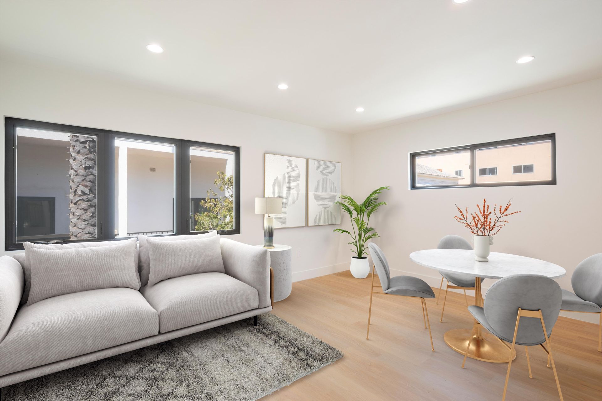 A living room with a couch , chairs and a table.