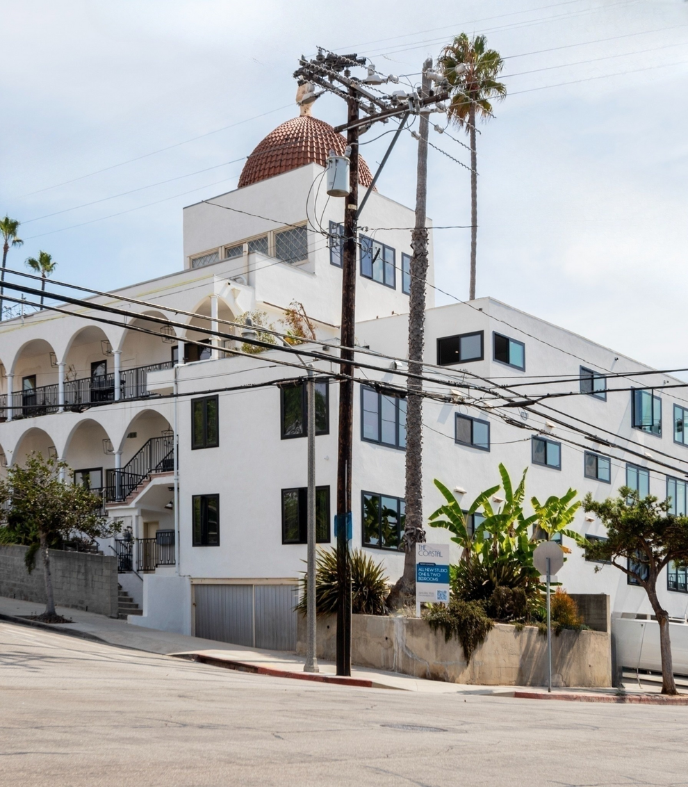 A large white building with a dome on top of it