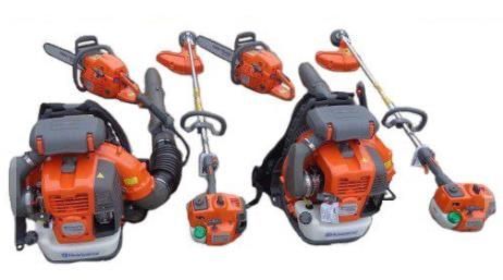 A chainsaw and a trimmer are sitting next to each other on a white background.