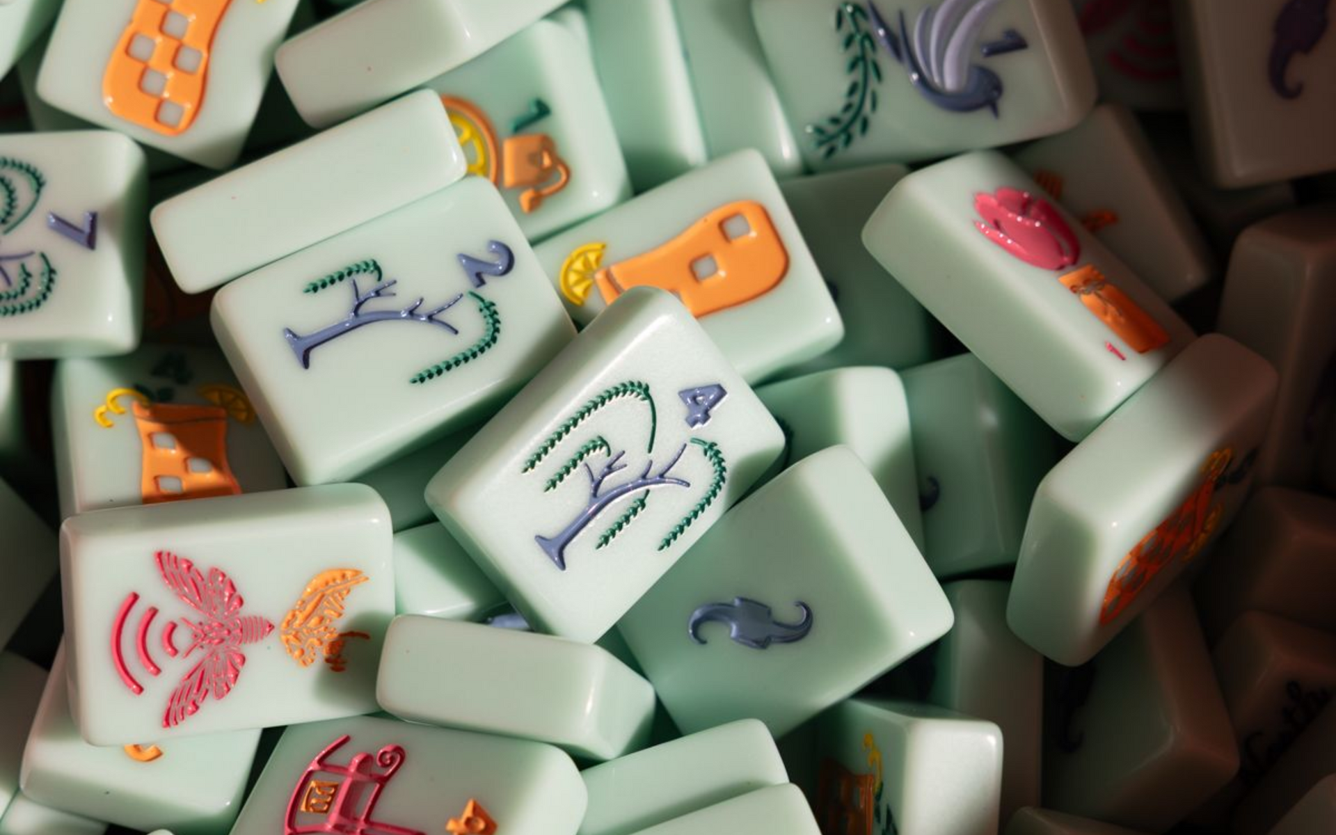 Scattered white domino-like tiles with colorful cartoon figures on them, piled together on a surface
