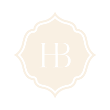 Pale cream decorative monogram logo with the letters “HB” in the center
