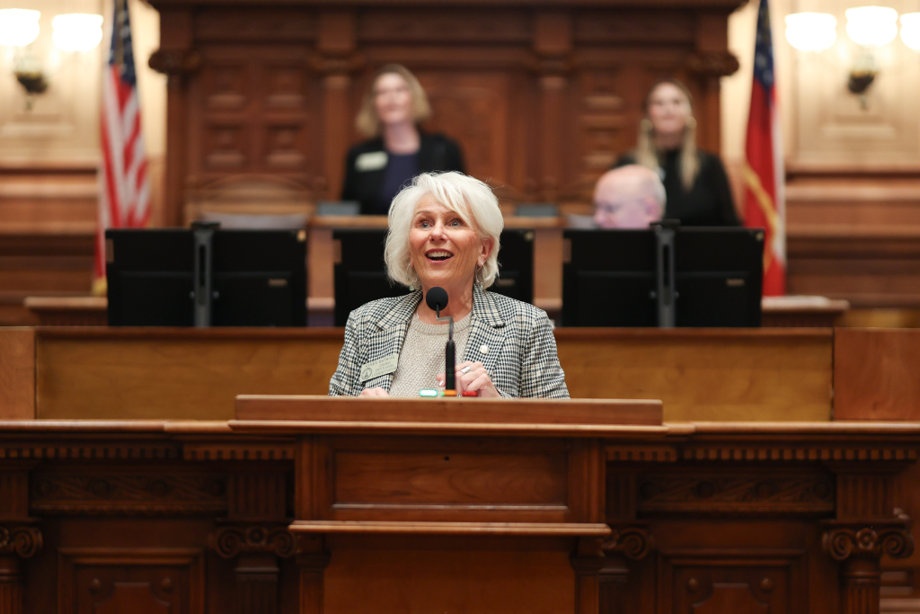 Karen Mathiak Georgia House 82 speaking at the podium.