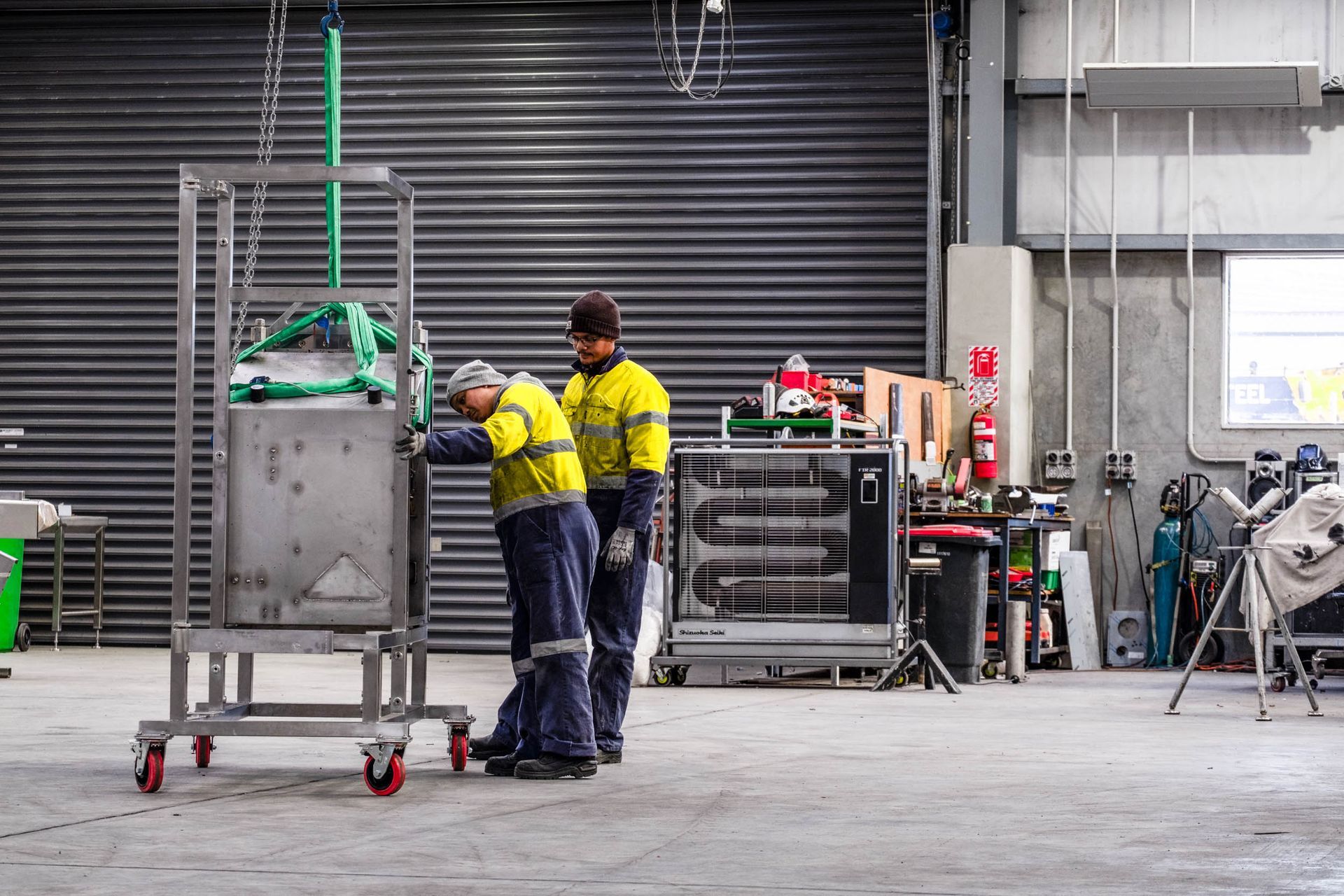 Training new engineering apprentices to use hoists in Christchurch factory.