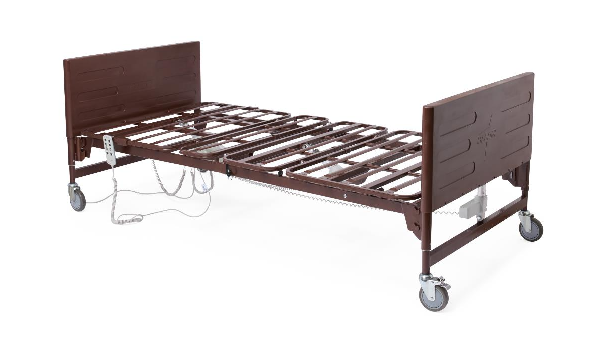 Hospital bed with white linens and a mint-green side panel in a bright room