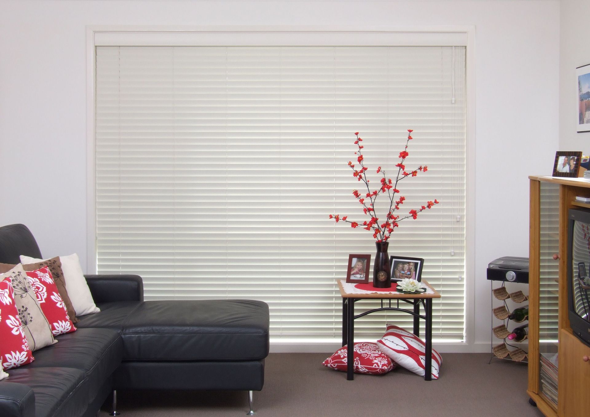 Living Room With a Couch and a Table With a Vase of Flowers — Curtain Force NQ in Garbutt, QLD
