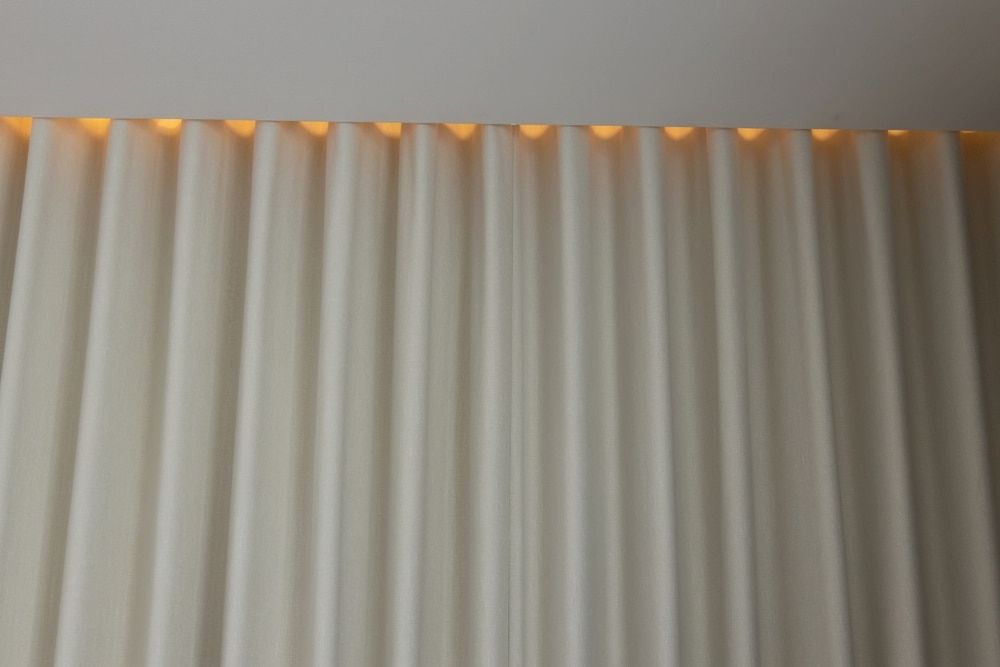 A White Curtain With a Light Behind It — Curtain Force NQ in Garbutt, QLD