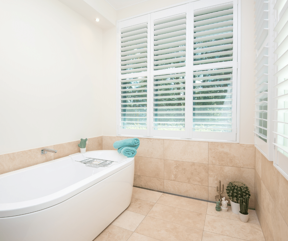 A Bathroom With a Bathtub and Shutters on the Windows  — Curtain Force NQ in Garbutt, QLD
