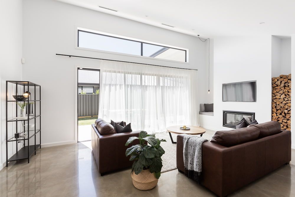 A Living Room With Two Couches, a Coffee Table, and a Fireplace — Curtain Force NQ in Garbutt, QLD
