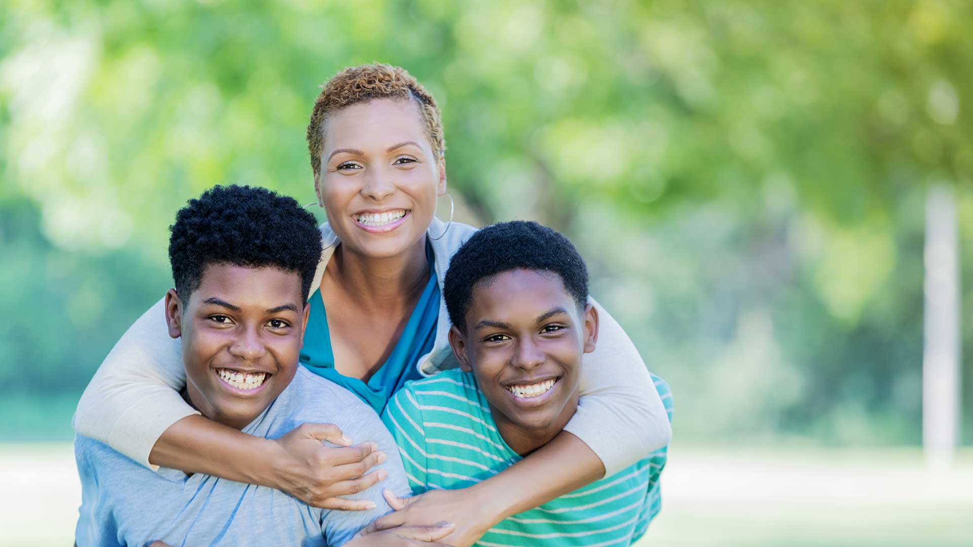 mom holding two kids