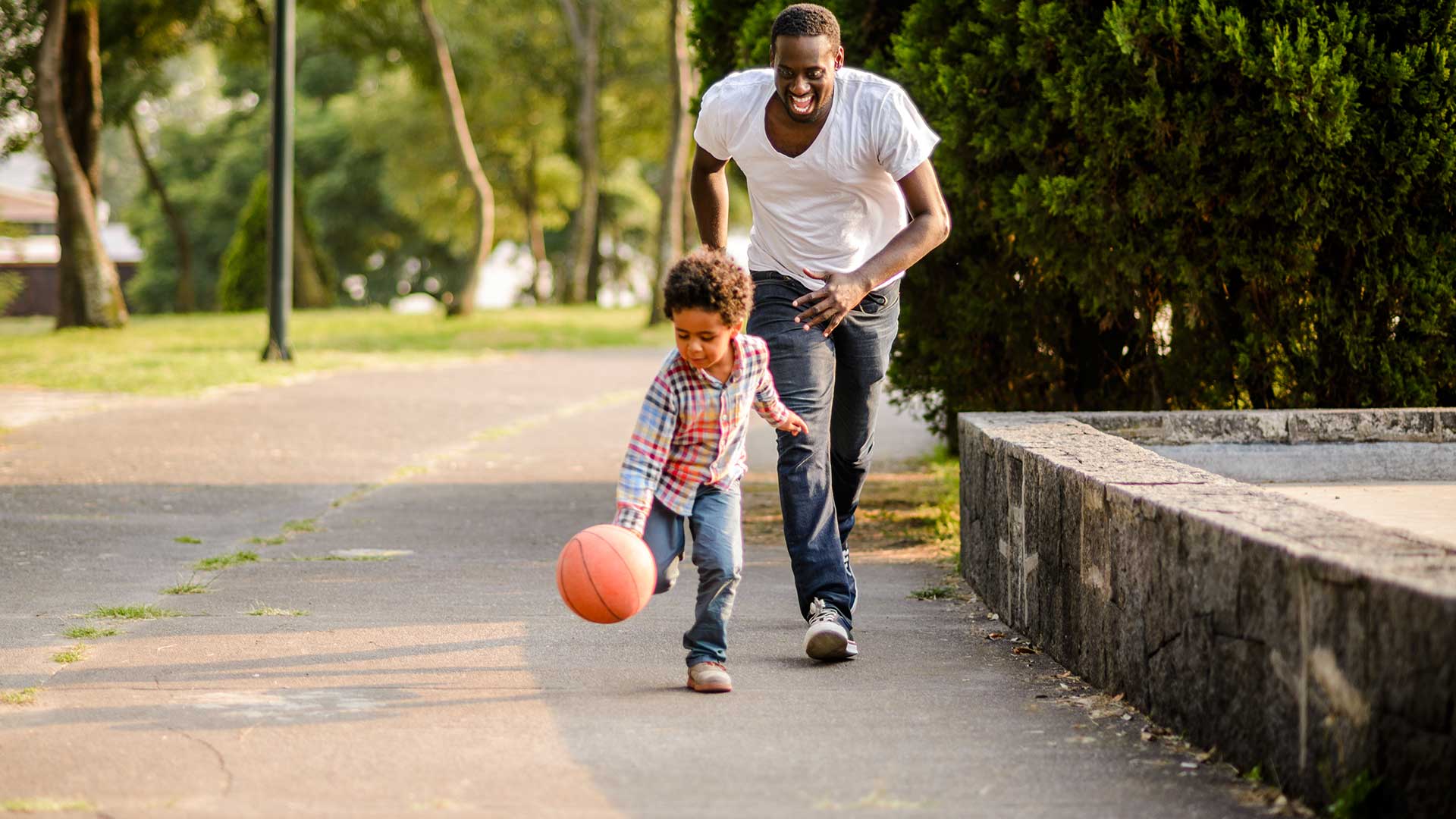 dad chasing boy with basketball