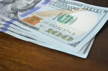 a stack of hundred dollar bills