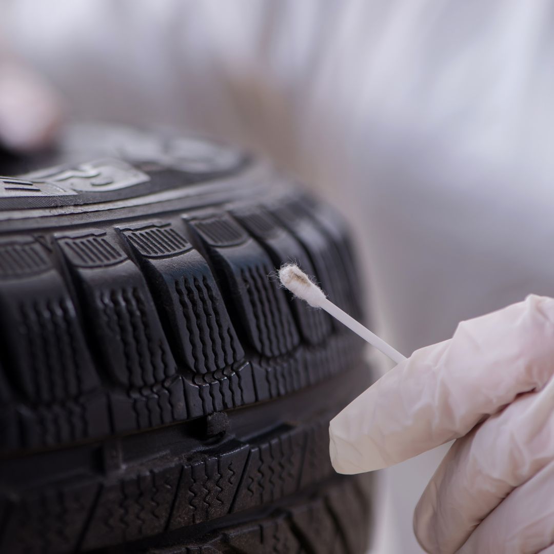 person collecting evidence from a tire