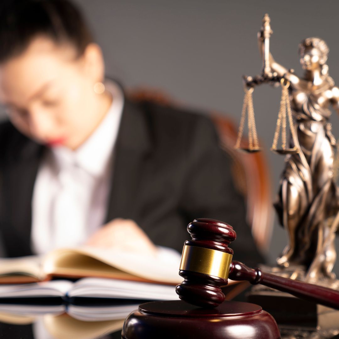 A statue of justice sits next to a judge 's gavel