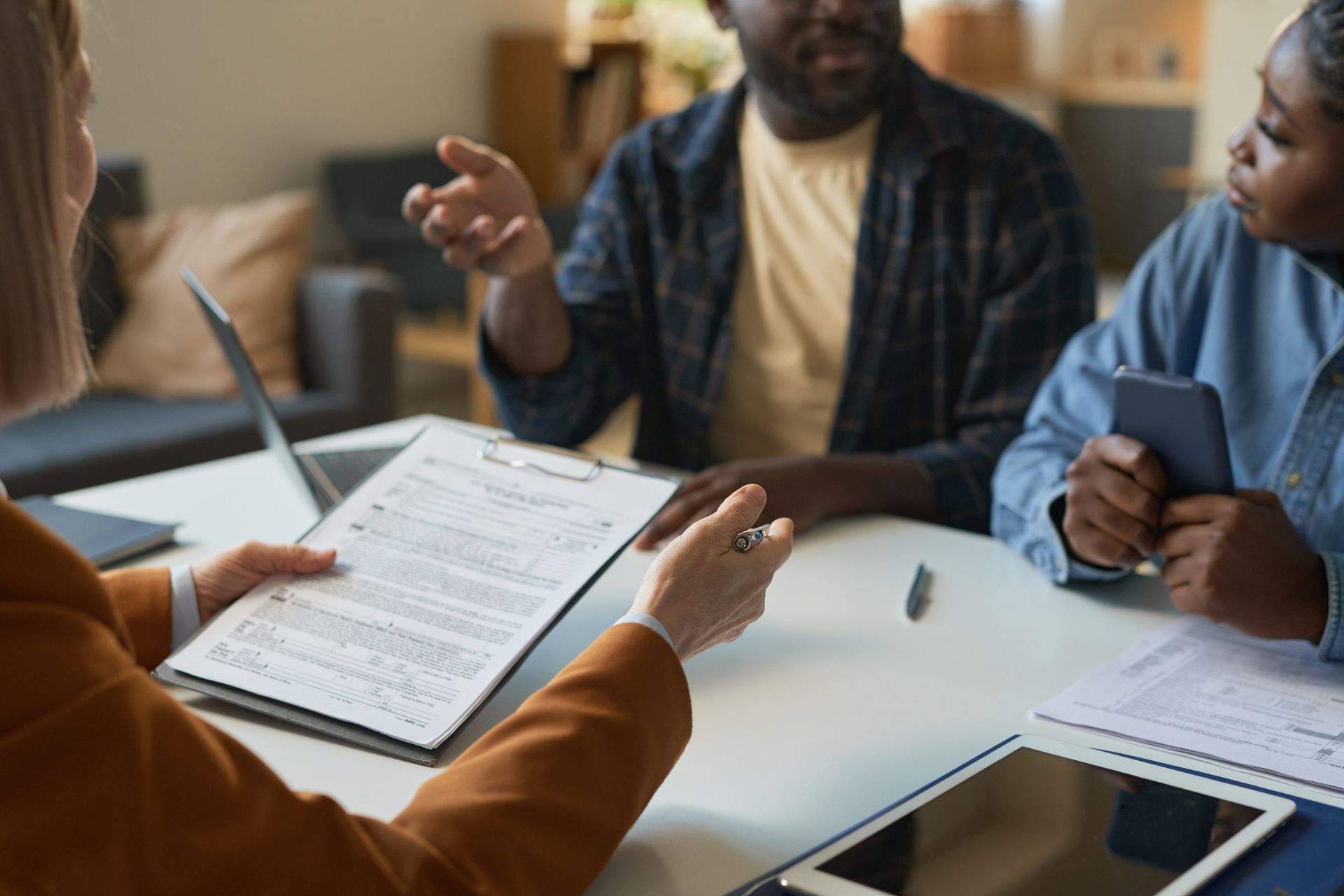 an attorney reviewing legal documents with a man and a woman