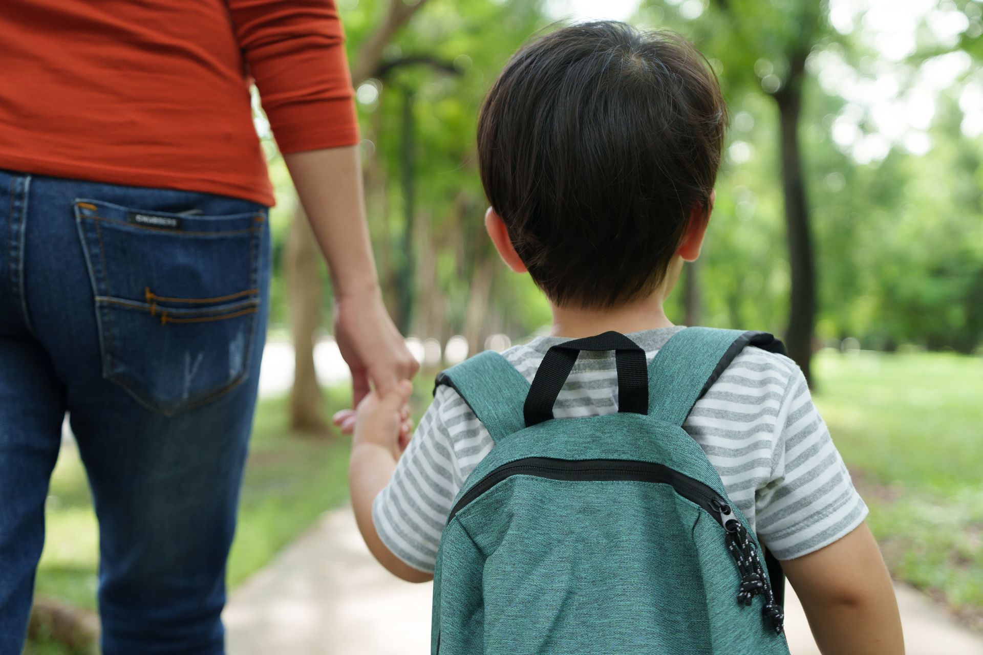 a parent and child walking hand in hand
