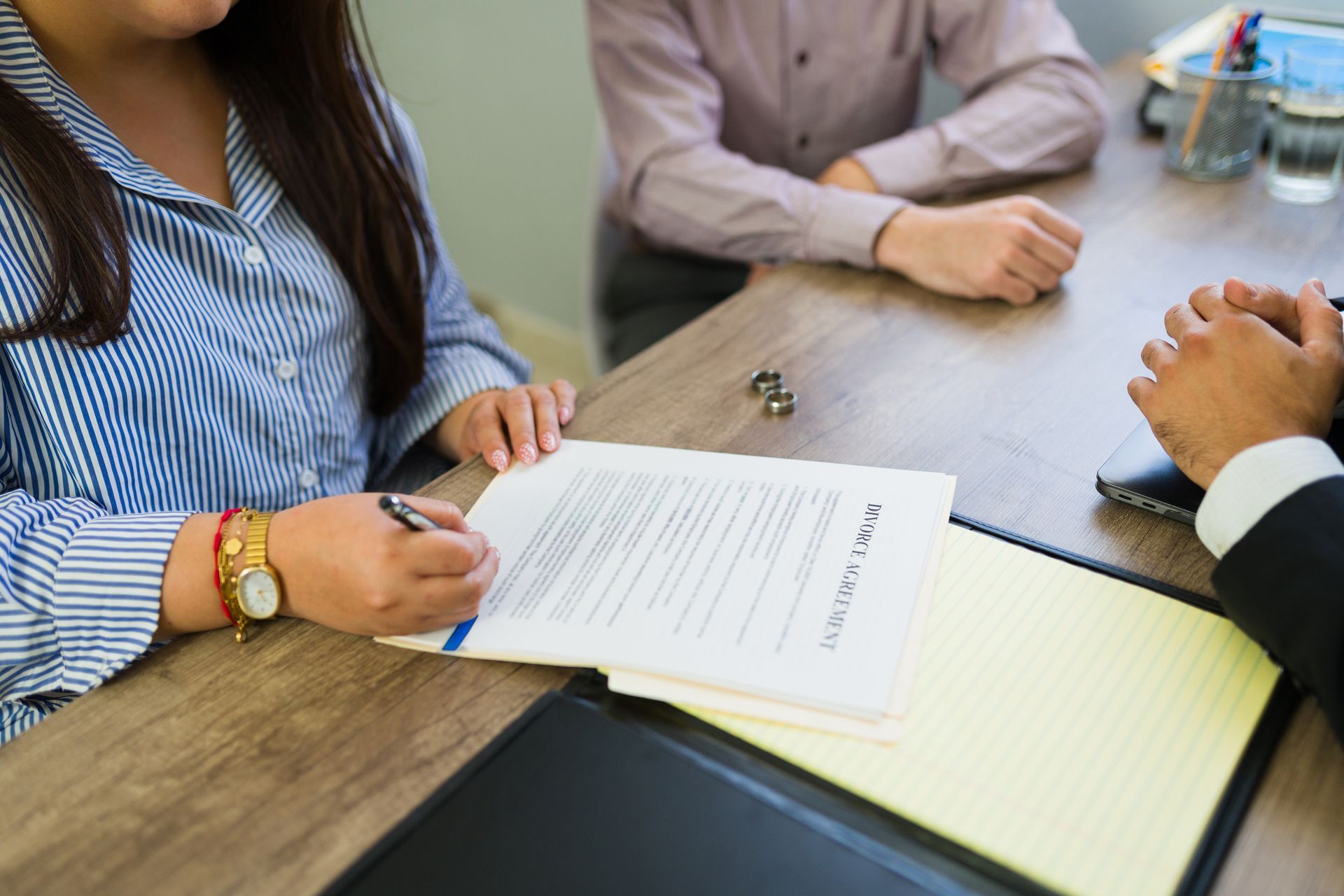 People in a meeting reviewing a document at a wooden conference table