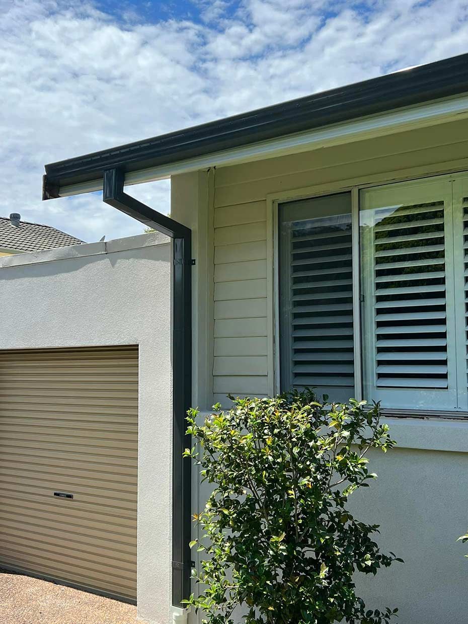 A House With a Roof Gutter and Window With Shutters on It — Gutterworx in Killarney Vale, NSW