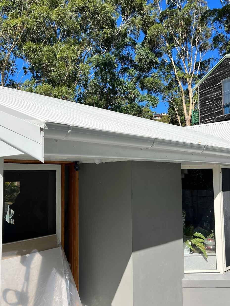 A House With a White Roof and Trees in the Background — Gutterworx in Gorokan, NSW
