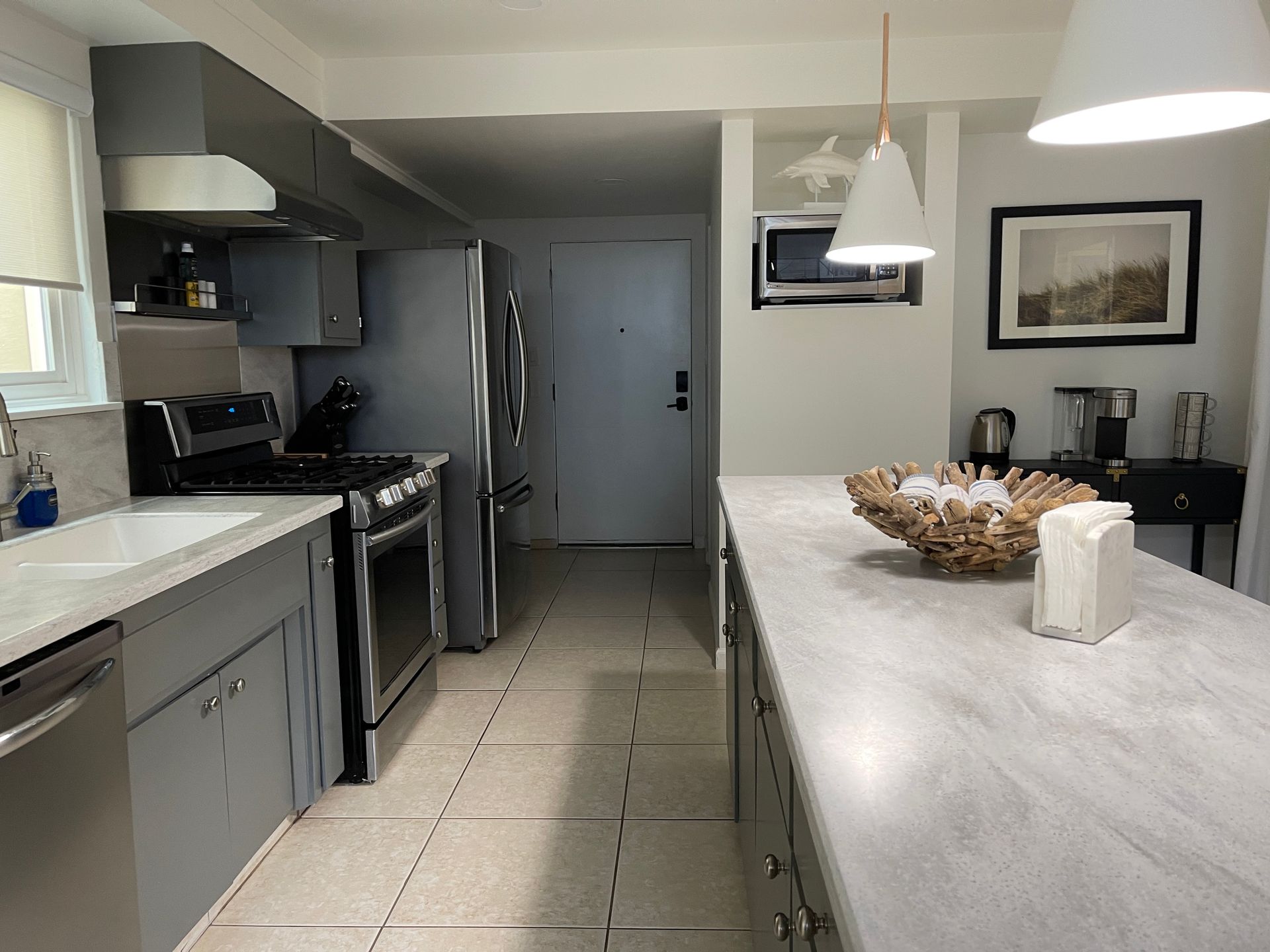 A kitchen with stainless steel appliances and a large island