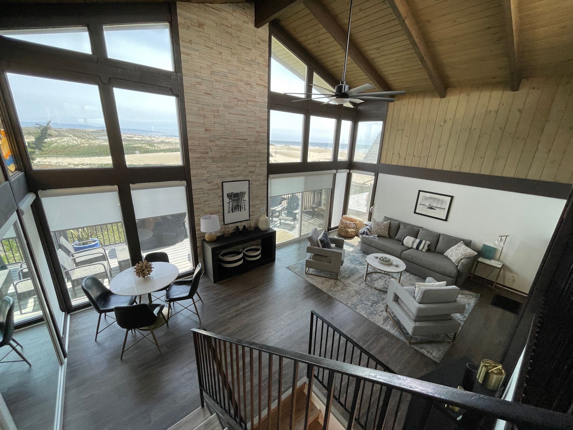 An aerial view of a living room with a couch , table and chairs.