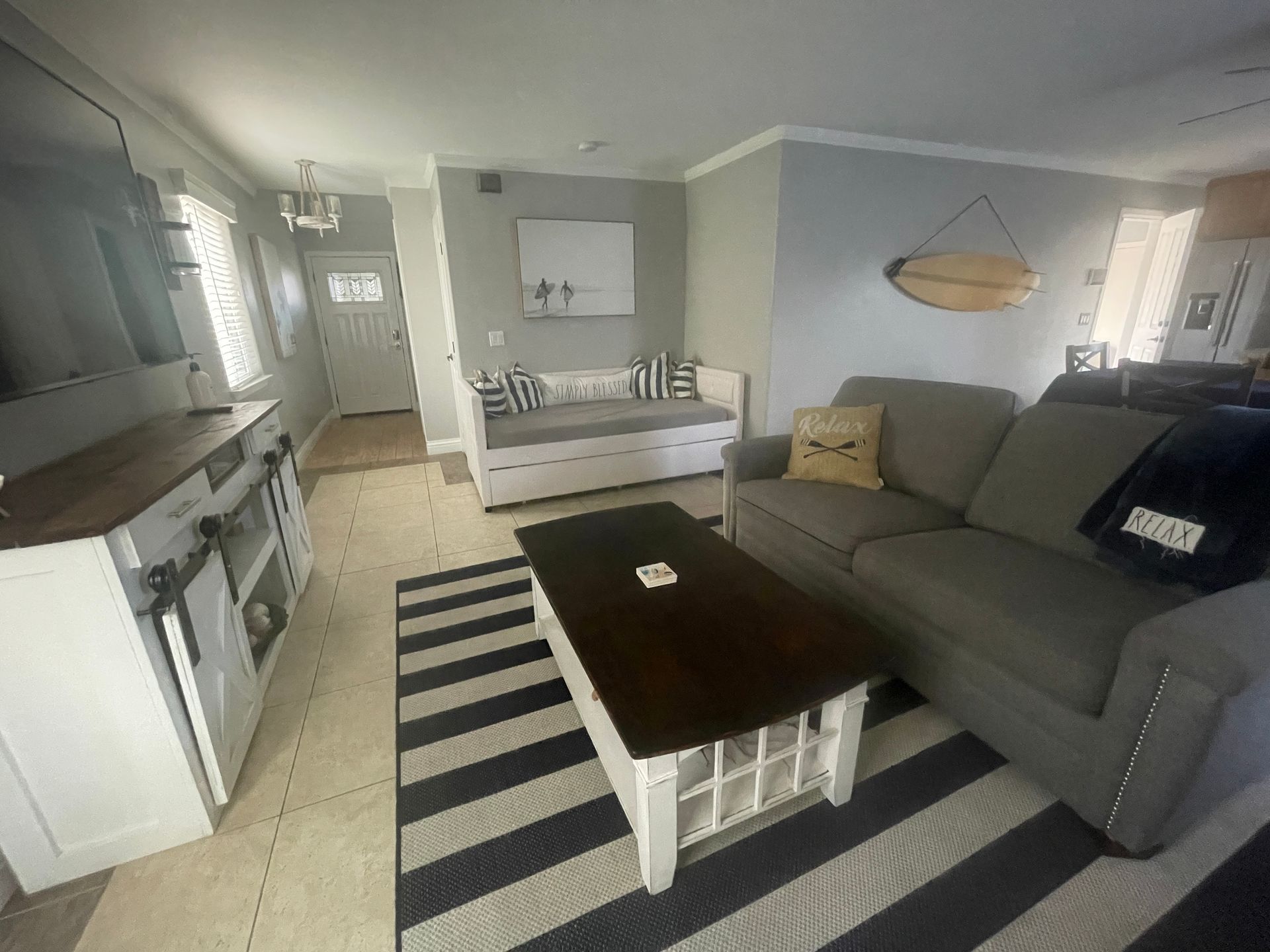 A living room with a couch , coffee table , and rug.