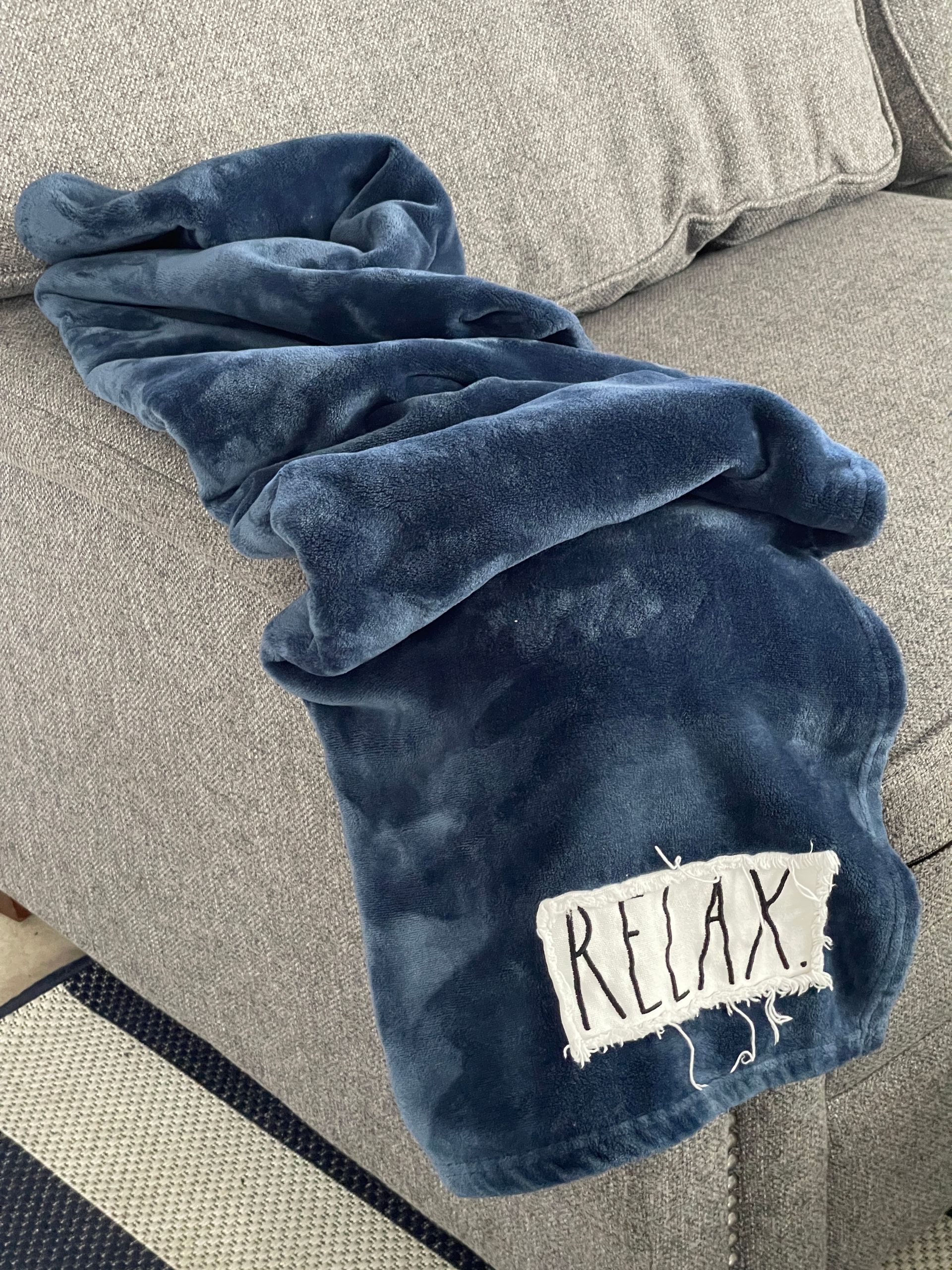 A blue blanket with the word relax on it