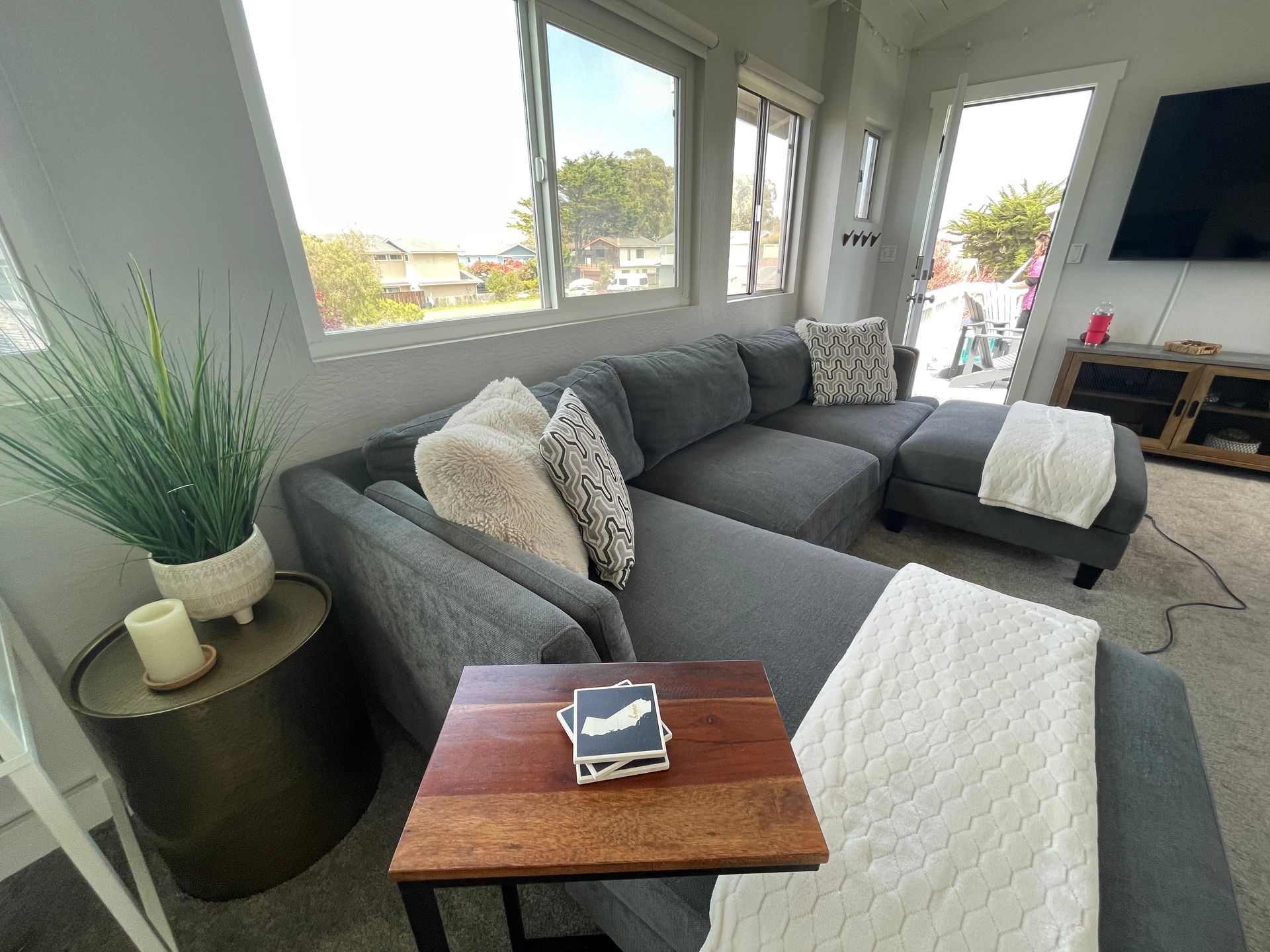 A living room with a couch , table , and television.