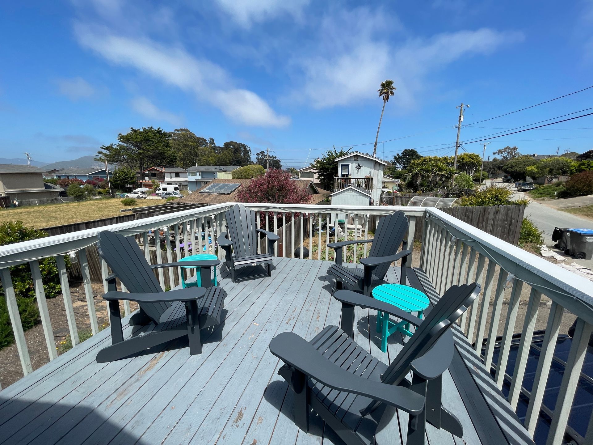A deck with chairs and tables on a sunny day