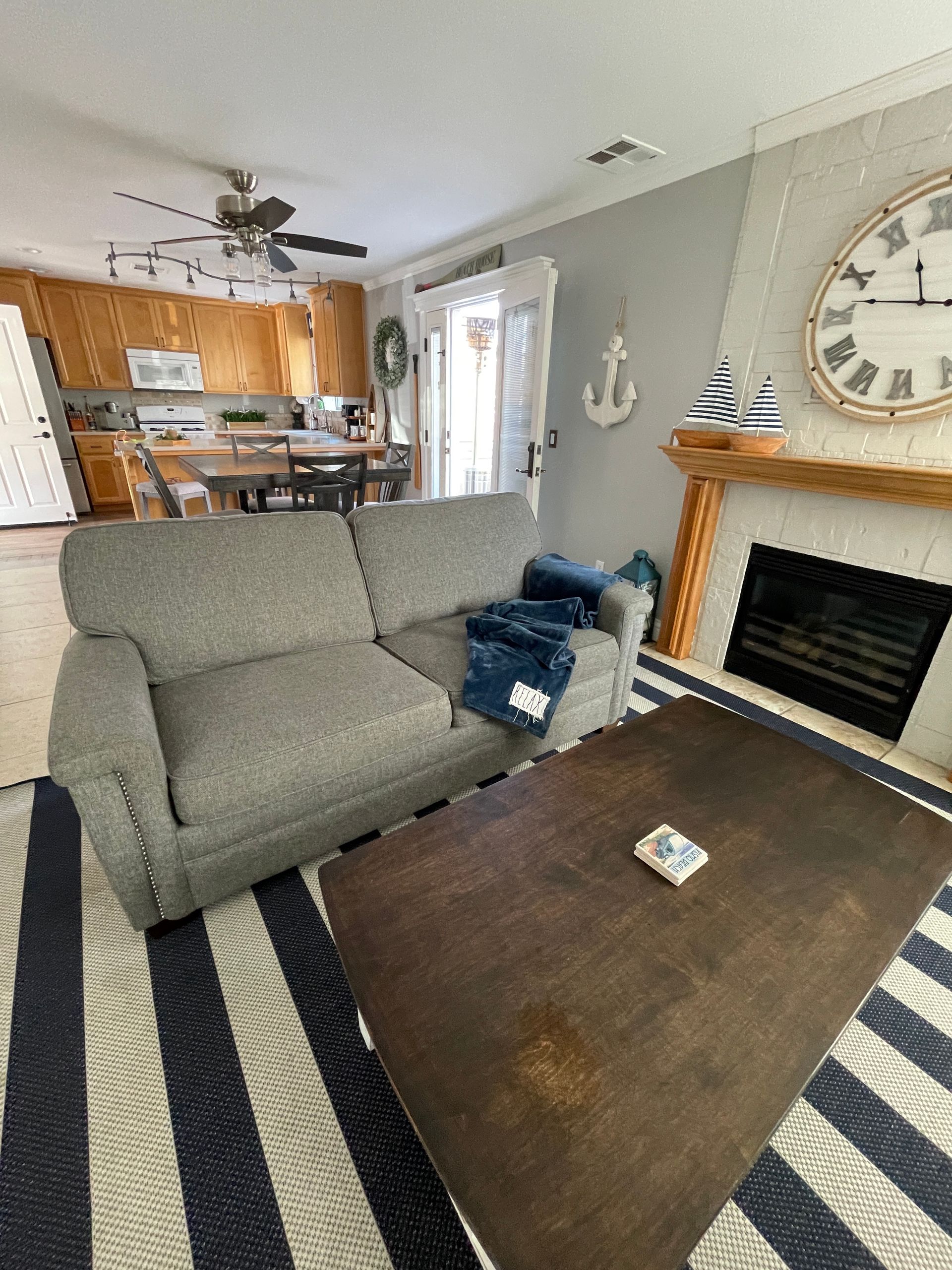 A living room with a couch , coffee table and fireplace.