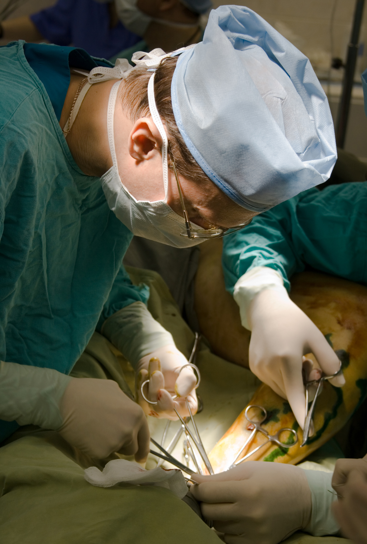 A surgeon is operating on a patient in an operating room