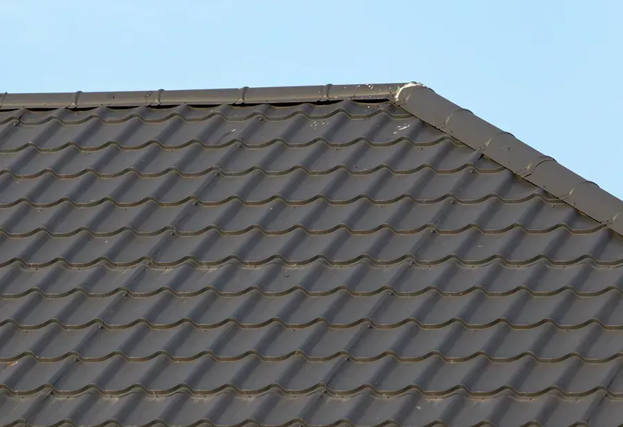 Gray tiled roof with a sloping ridge and visible roof vents