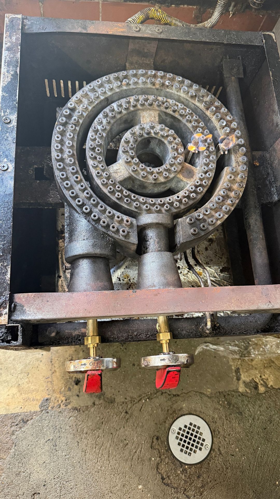 Industrial pipes with six colorful valve wheels on a teal pipeline system