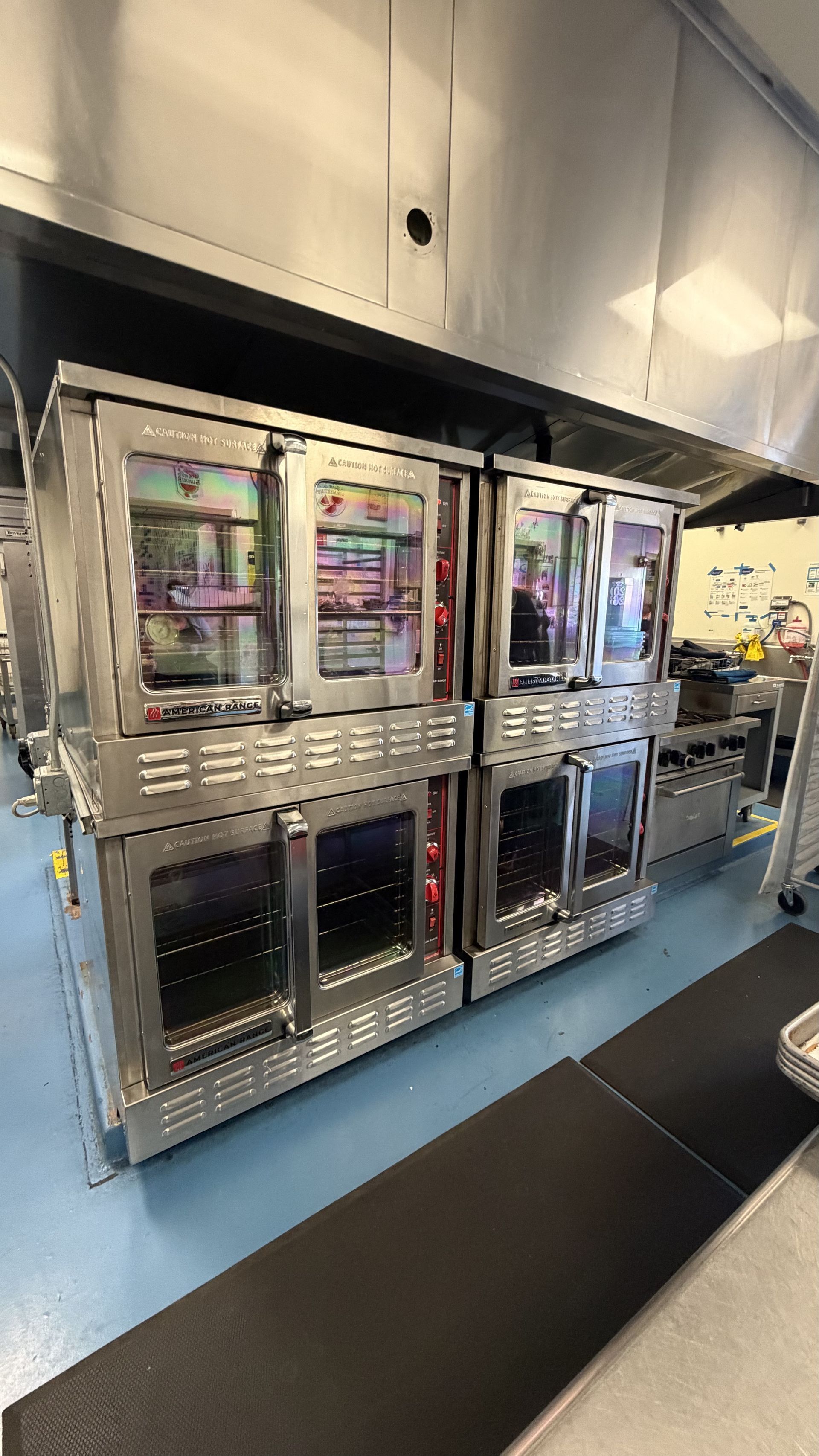 Modern stainless-steel commercial kitchen refrigeration and storage units in a professional kitchen