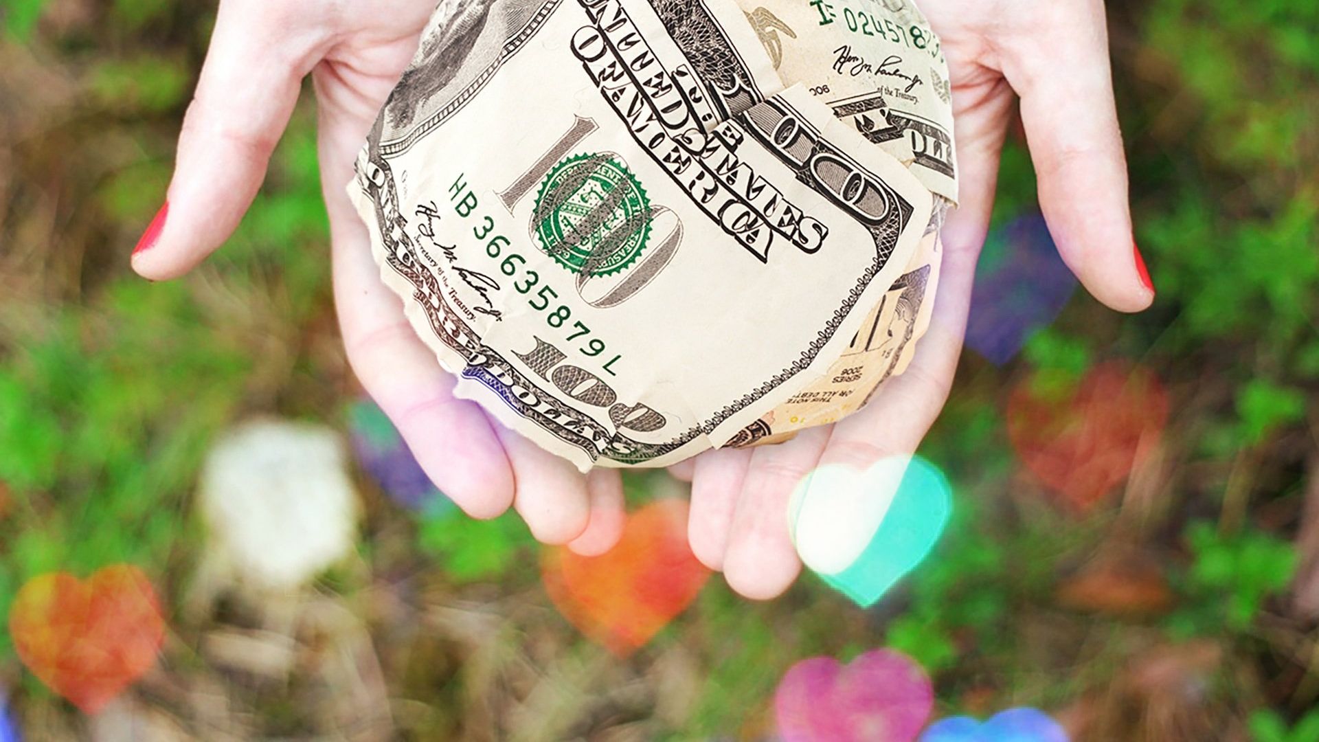 a woman is holding a dollar bill in her hands .
