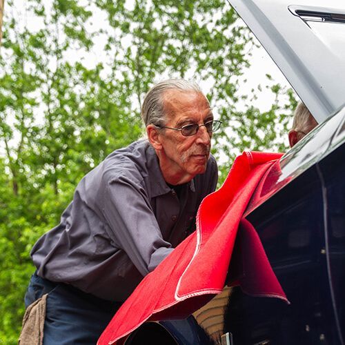 Our Mechanic Works on Vehicle with Opened Hood - Willie's Garage