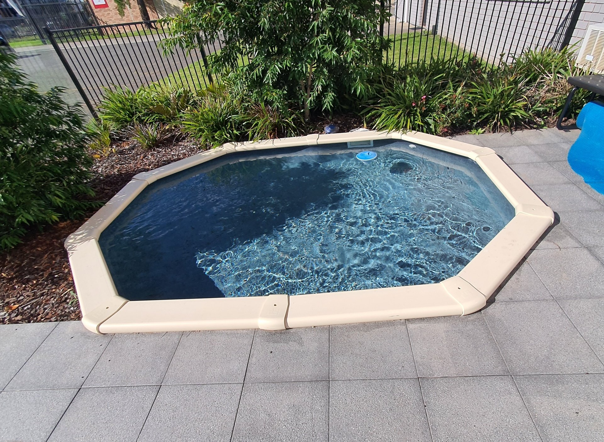 Walking Down Ladder into Pool — Pool Installation in Macquarie Fields, NSW Walking Down Ladder into Pool — Pool Installation in Macquarie Fields, NSW