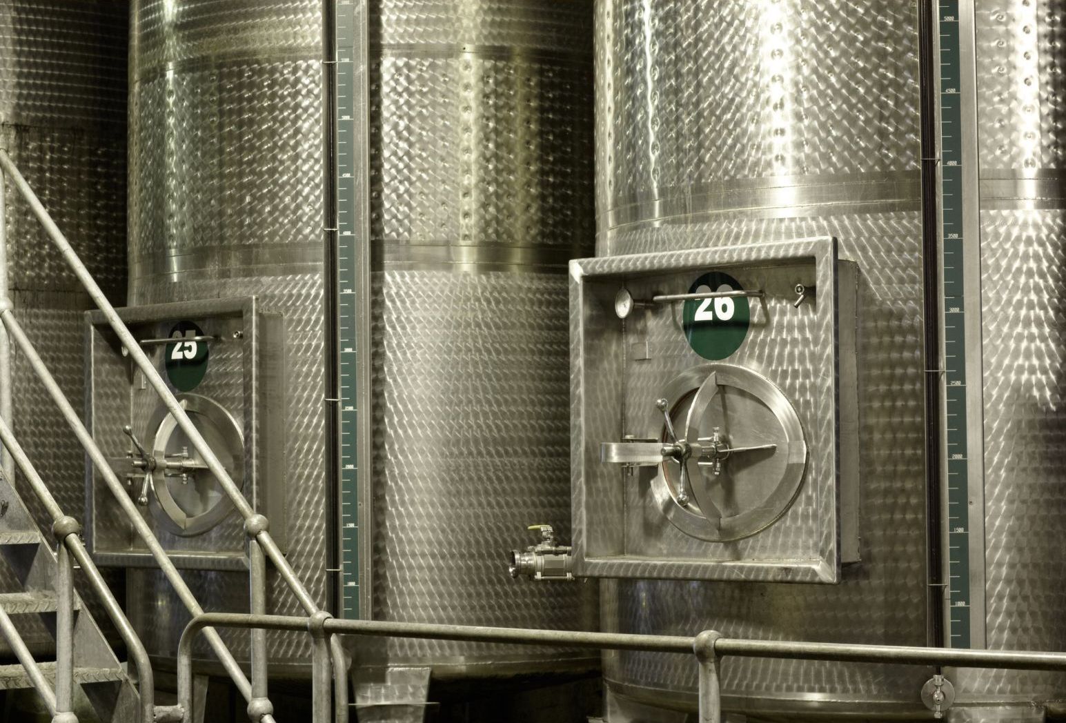 A row of stainless steel tanks with the number 20 on them