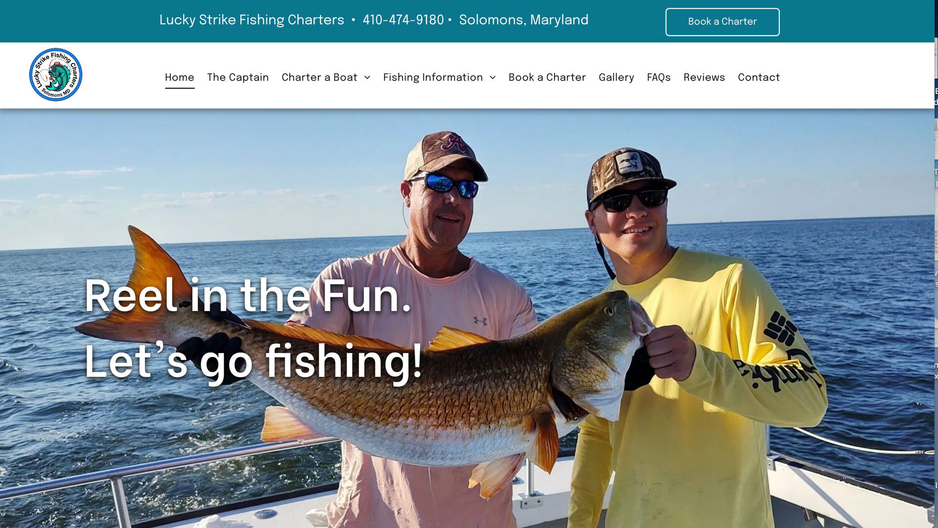 Two men are standing on a boat holding a large fish.