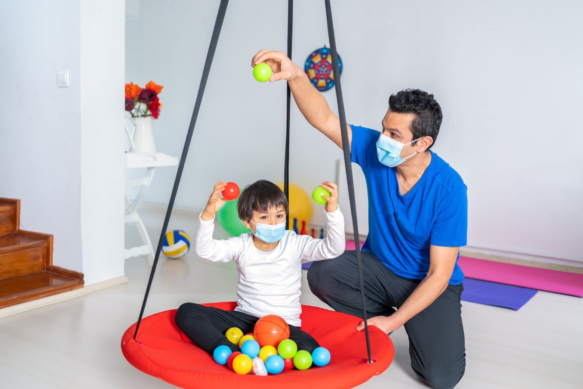 A man is Playing With a Child on a Swing - Pendleton, IN - Assent Therapy ABA