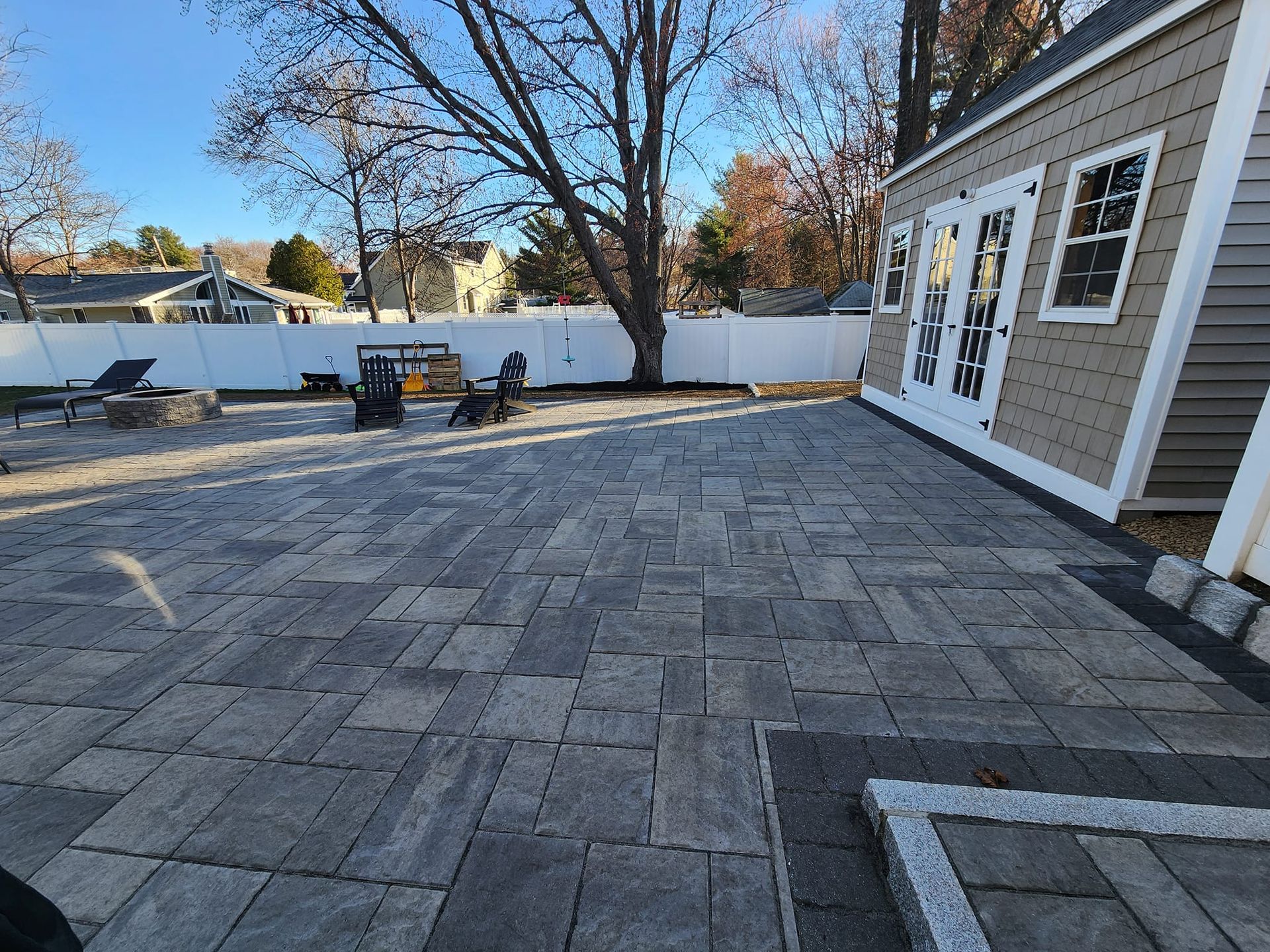 Patio with gray pavers, cobblestones by shed