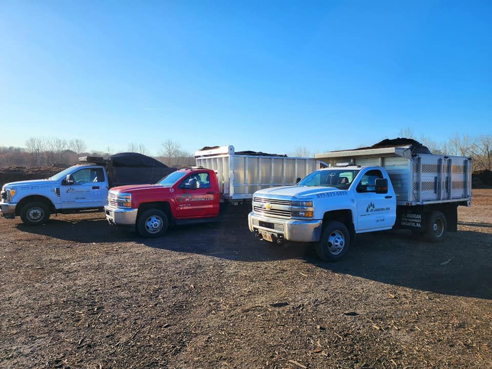 Three trucks loaded with mulch ready to work!