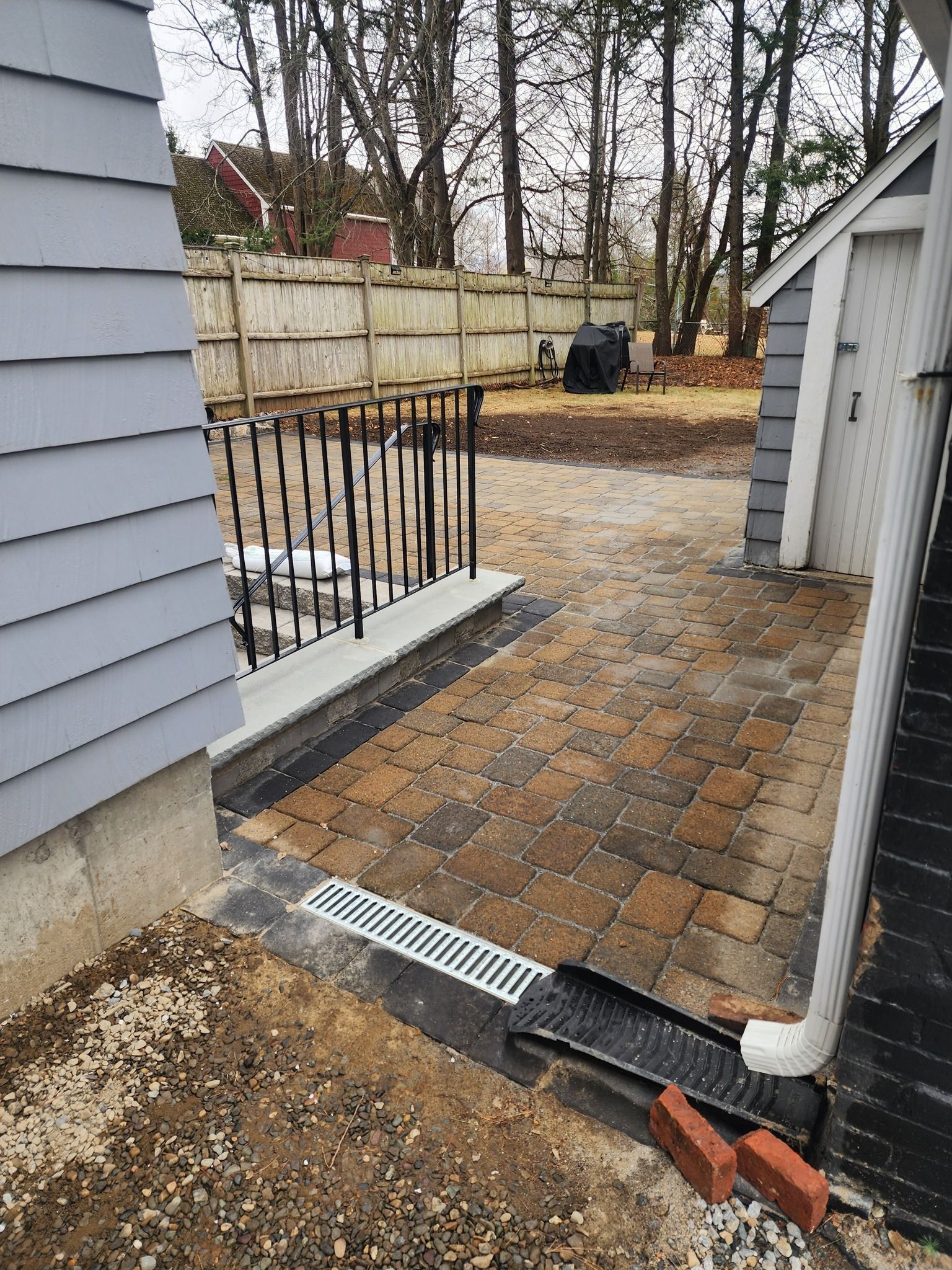 New paver patio with drainage solutions installed in this backyard