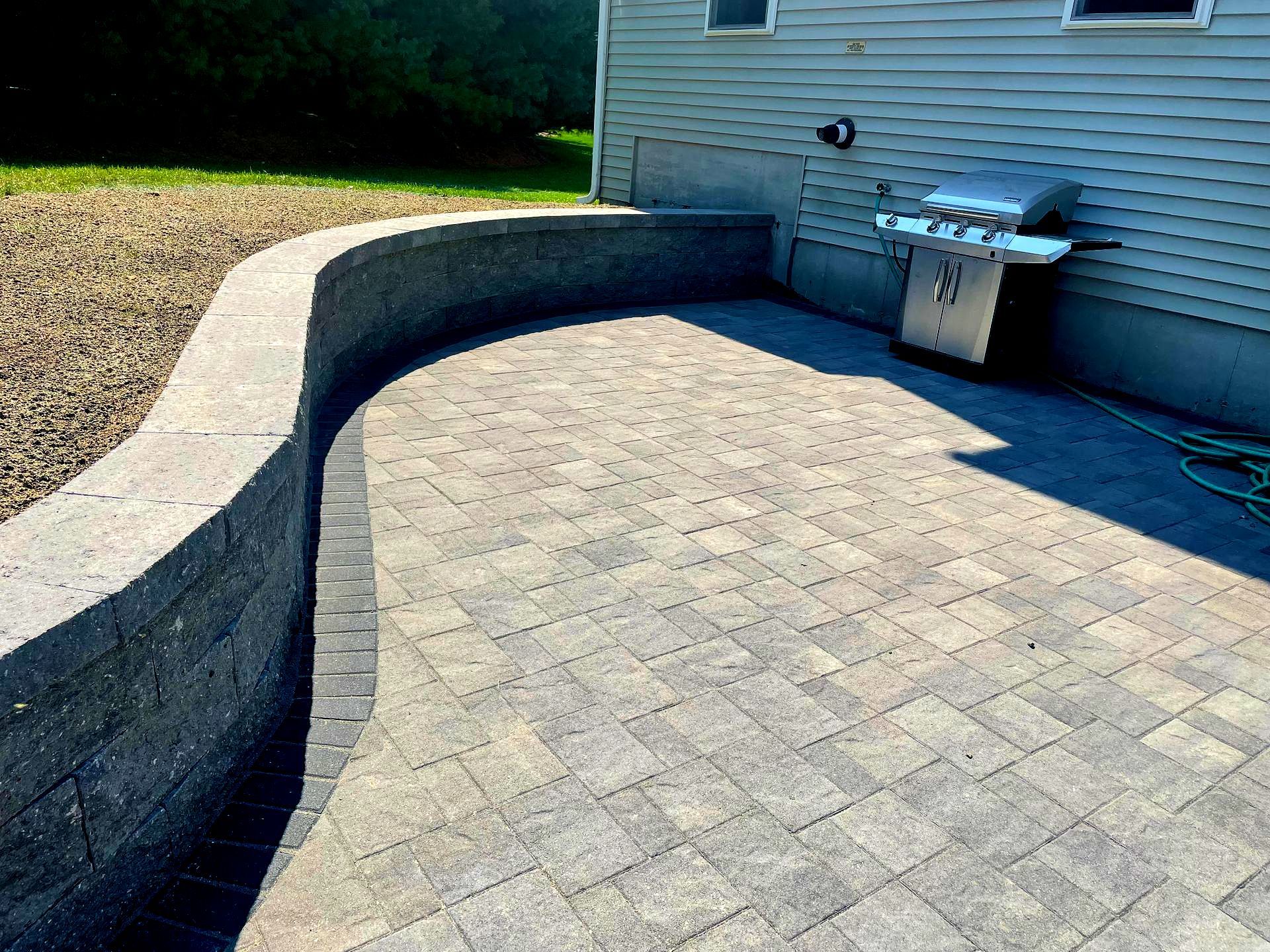 Decorative retaining block wall in Manchester-by-the-Sea, MA. Retaining wall and patio project.
