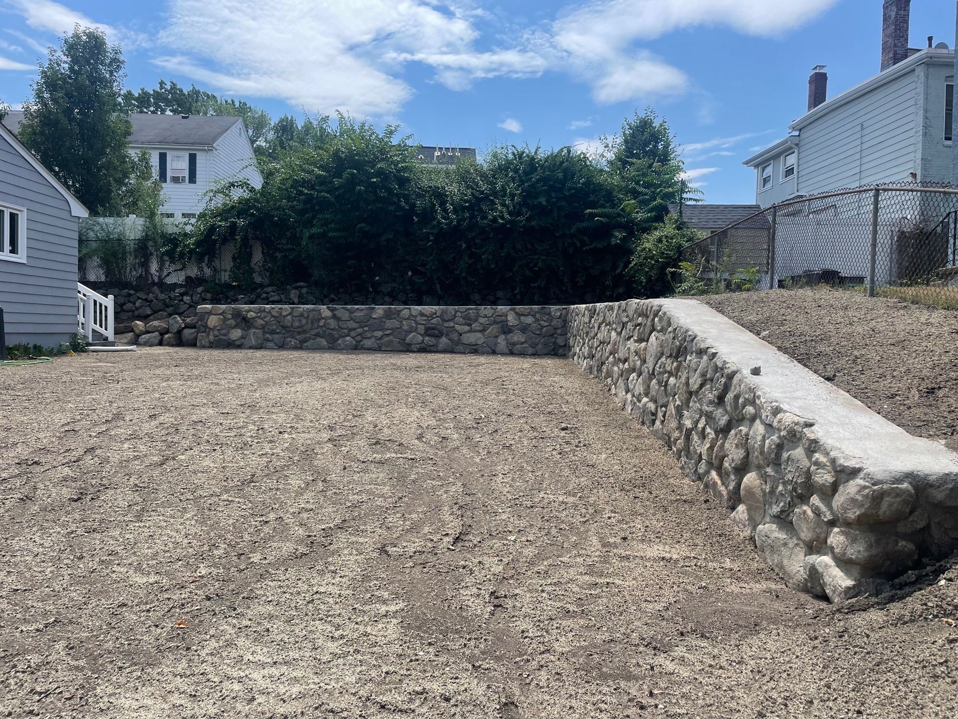 New lawn installed. Graded with the addition of a brand new New England fieldstone retaining wall