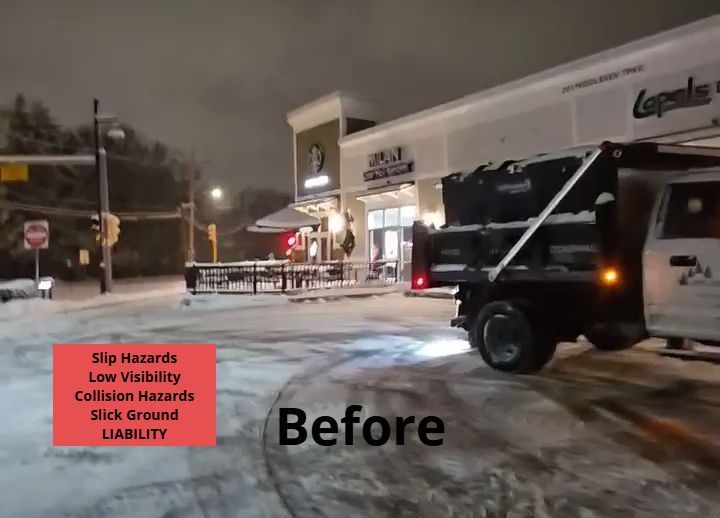 Snowy scene: Dump truck by a shopping plaza at night. Salting parking lot and plowing snow. 