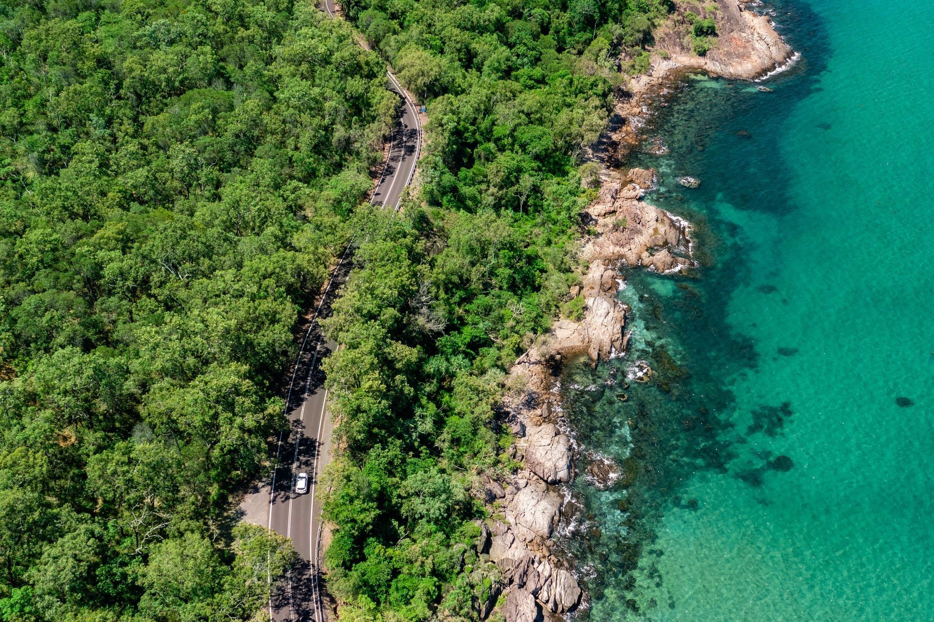 Aerial view of vehicle driving along the Captain Cook Highway from Cairns to Port Douglas