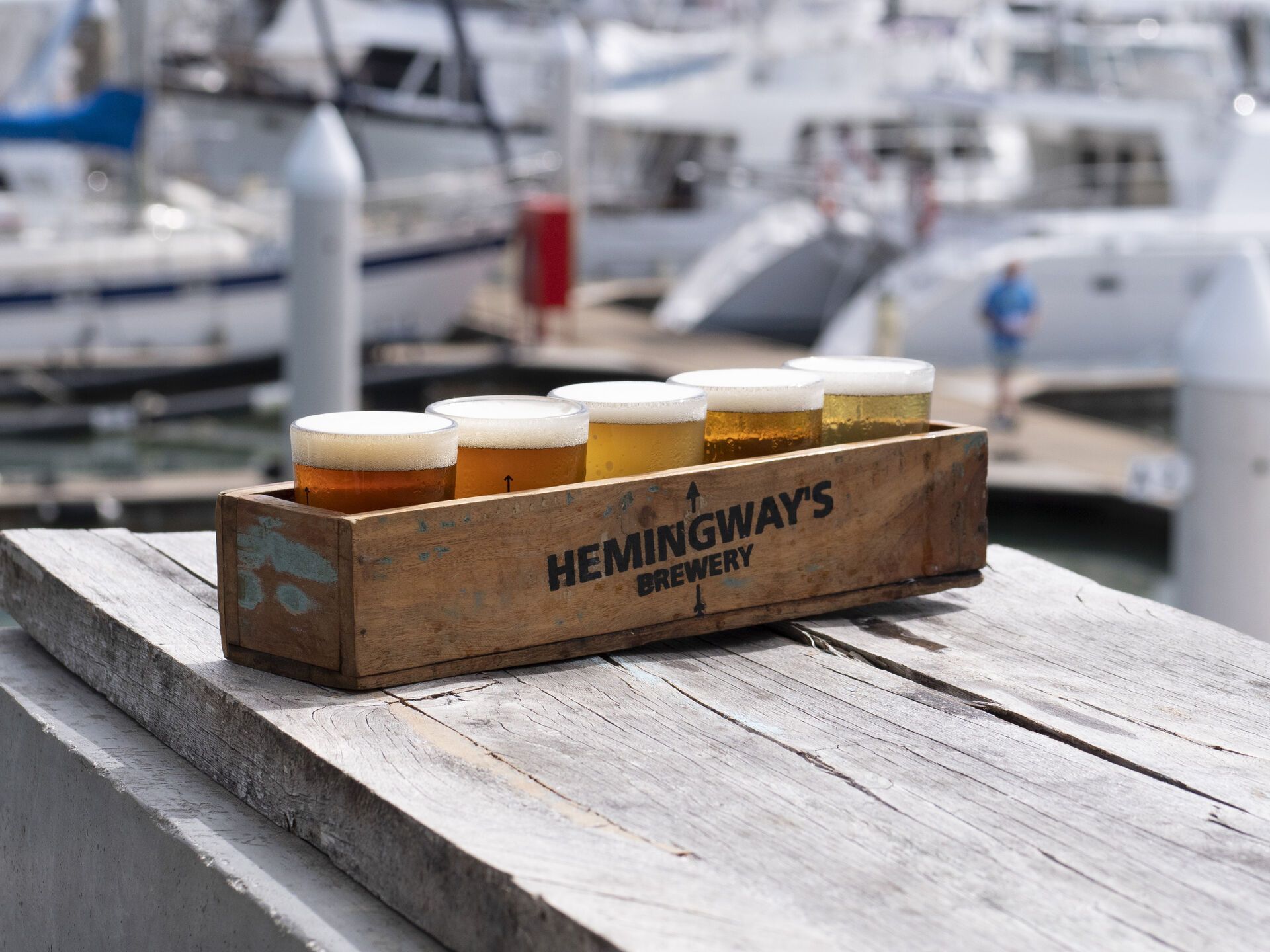 Tasting platter of beers at Hemingways Brewery Port Douglas with the marina in the background