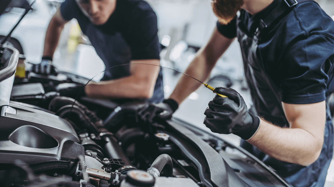 two mechanics doing a fluid change